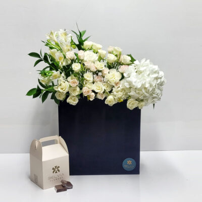 Fresh flowers black box with chocolate